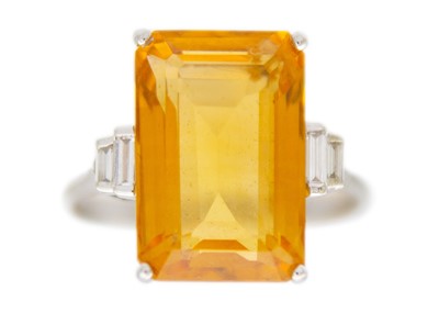 Lot 105 - An orange citrine and diamonds 18k white gold dress ring.
