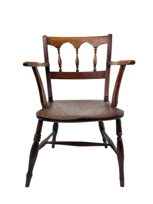 Lot 312 - A fruitwood and elm Windsor armchair.