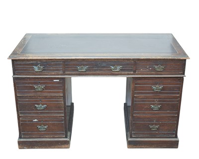 Lot 496 - An Edwardian walnut kneehole twin pedestal desk.