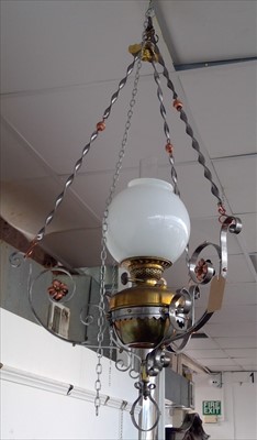 Lot 251 - A hanging oil lamp, the wrought metal frame...