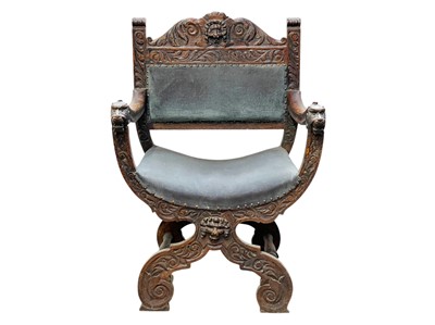 Lot 432 - An oak Savonarola type armchair.