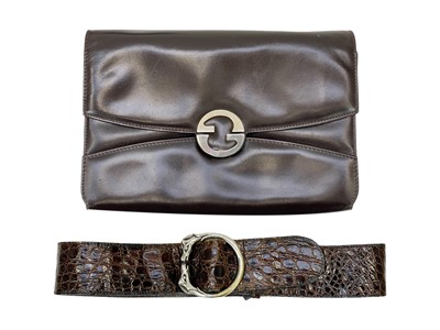 Lot 262 - A Gucci brown leather clutch bag and a Gucci croc leather belt.