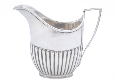 Lot 19 - An Edwardian silver cream jug, and a pair of George IV sugar tongs.