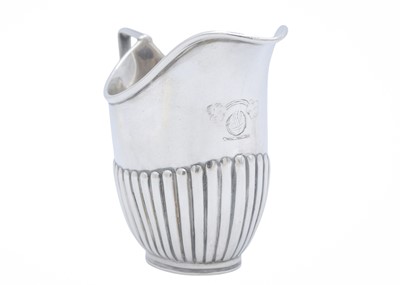 Lot 19 - An Edwardian silver cream jug, and a pair of George IV sugar tongs.