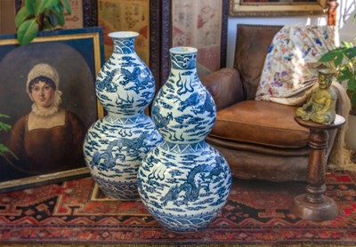 Lot 696 - An enormous matched pair of Chinese blue and white double gourd floor vases.