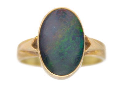 Lot 211 - An opal triplet solitaire ring in 9k yellow gold.