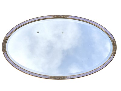 Lot 335 - An oval painted and gilt wall mirror.