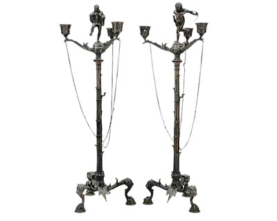 Lot 142 - A pair of ornate bronze three branch candelabra.