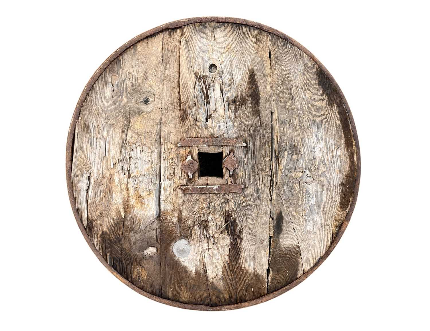 Lot 31 - A Middle Eastern oak and wrought iron cartwheel.