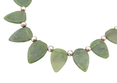 Lot 41 - CHRISTINE POVEY - a jadeite necklace in silver, boxed.