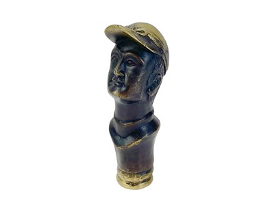 Lot 110 - A brass and lacquered brass cane handle, cast as a jockey.