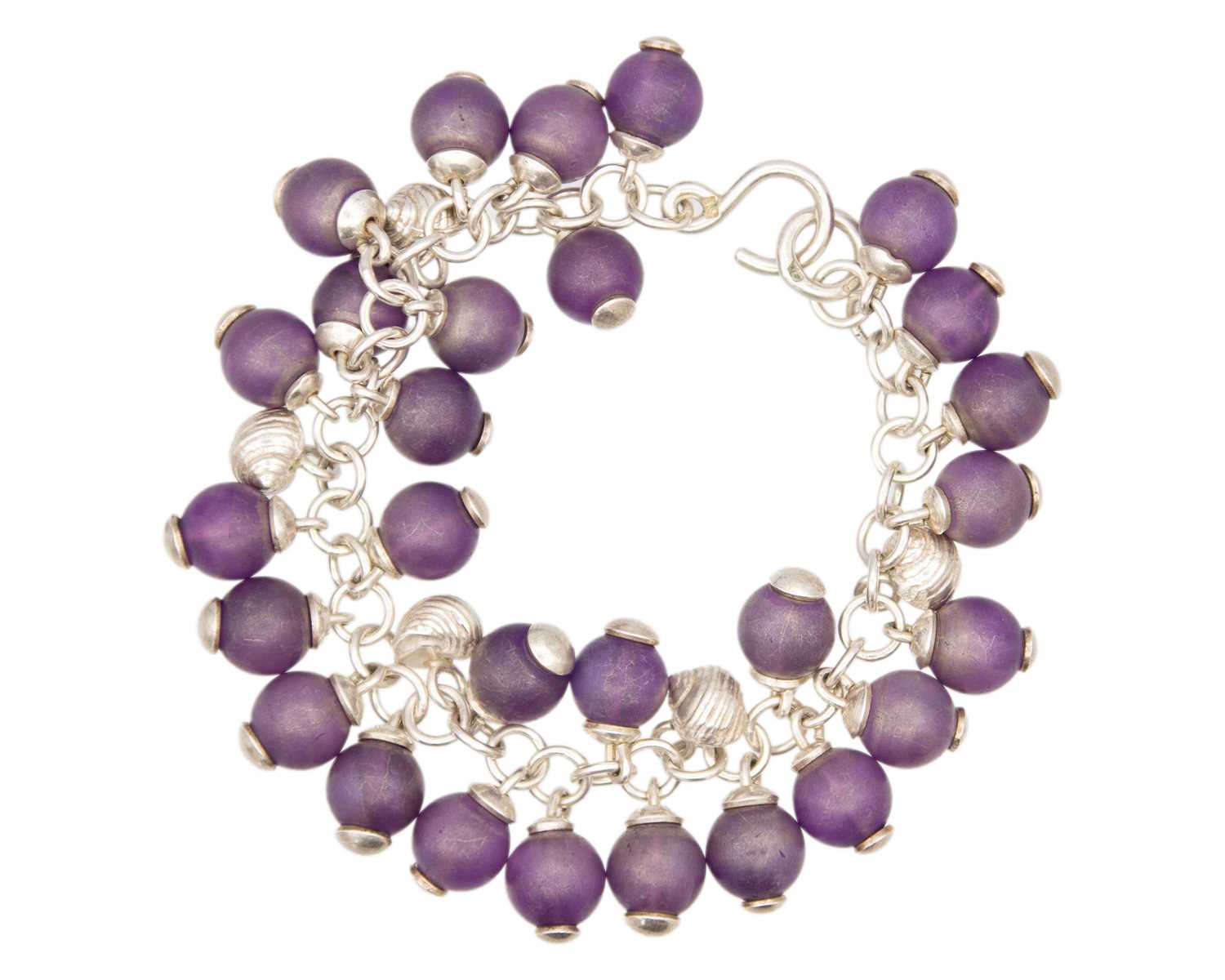 Lot 76 - FAY PAGE, ISLES OF SCILLY - A silver and amethyst bead set bracelet.