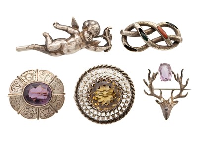 Lot 26 - A selection of four Scottish silver brooches and a cherub brooch.