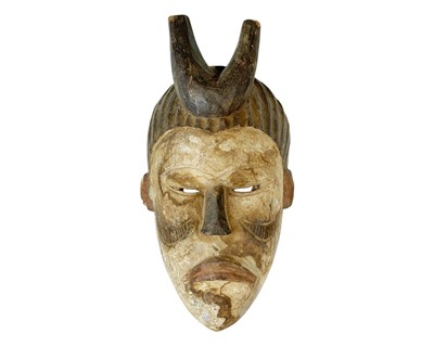 Lot 22 - A polychrome African mask.