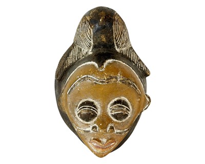 Lot 119 - A Punu carved wood mask.