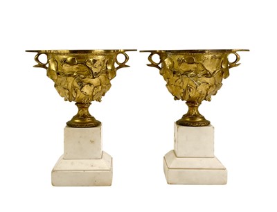 Lot 125 - A decorative pair of French gilded bronze urns.