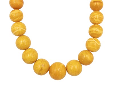 Lot 33 - A large butterscotch amber graduated bead necklace.