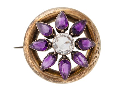 Lot 13 - A Victorian rose gold (tests 9k) amethyst and rock crystal set circular brooch.