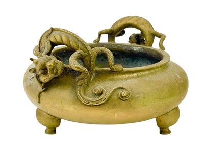 Lot 753 - A Chinese polished bronze 'dragon' tripod censer.
