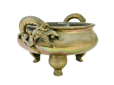 Lot 714 - A Chinese polished bronze tripod 'dragon' censer.