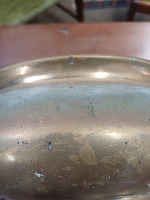 Lot 714 - A Chinese polished bronze tripod 'dragon' censer.