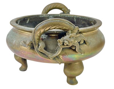 Lot 714 - A Chinese polished bronze tripod 'dragon' censer.