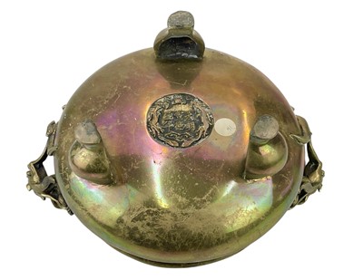 Lot 714 - A Chinese polished bronze tripod 'dragon' censer.