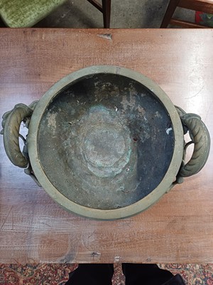 Lot 714 - A Chinese polished bronze tripod 'dragon' censer.