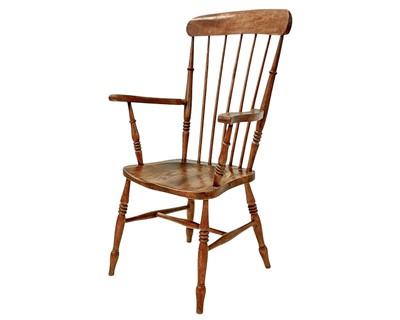 Lot 428 - A beech and elm kitchen stick back Windsor elbow chair.