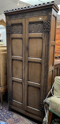 Lot 3139 - A reproduction oak hall cupboard, with carved...