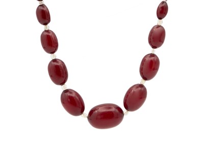 Lot 49 - A cherry amber bakelite and paste bead necklace.