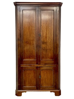 Lot 422 - A late George III mahogany standing corner cupboard.
