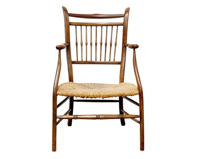 Lot 443 - An Arts and Crafts style fruitwood low elbow chair.
