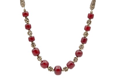 Lot 54 - A cherry amber bakelite bead and white metal necklace.
