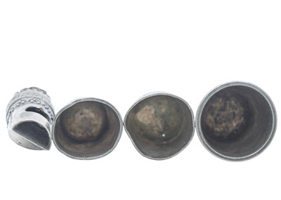 Lot 13 - A novelty owl whistle, together with three silver thimbles.