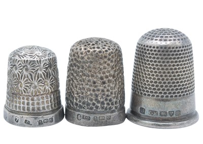 Lot 13 - A novelty owl whistle, together with three silver thimbles.