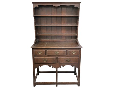 Lot 509 - A George III style oak cottage dresser.