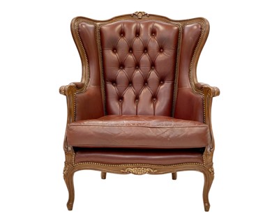 Lot 425 - A French leather wing back armchair.