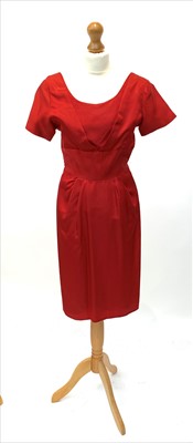 Lot 2802 - A circa 1950s short sleeved red satin knee...