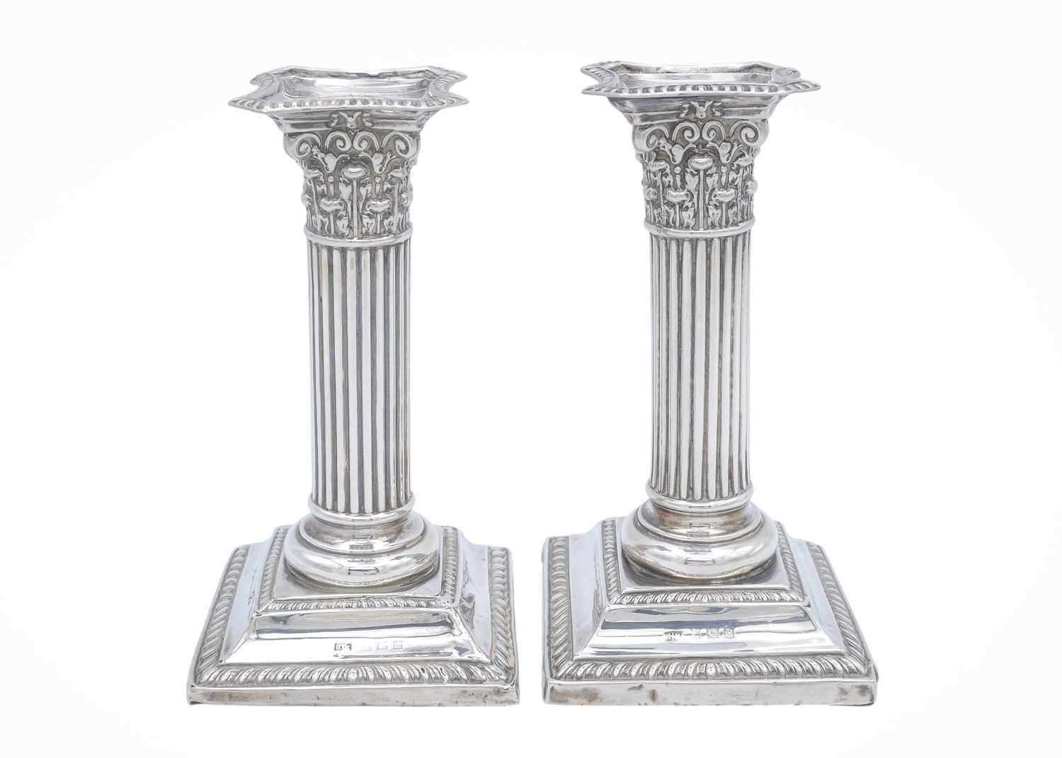 Lot 17 - A pair of Edward VII silver Corinthian candlesticks by Henry Matthews.