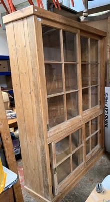 Lot 3218 - A pine two-part cabinet, the upper section...