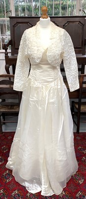 Lot 2803 - A British designer couture 1980s ivory satin...