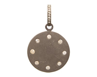 Lot 104 - An oxidized silver diamond set disc pendant.