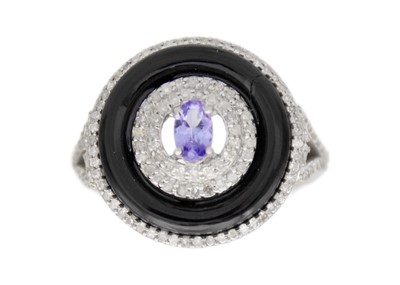 Lot 112 - A silver tanzanite, diamond, and onyx target-style dress ring.