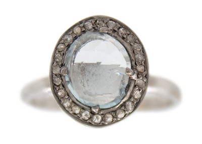 Lot 119 - A silver aquamarine and diamond set halo ring.
