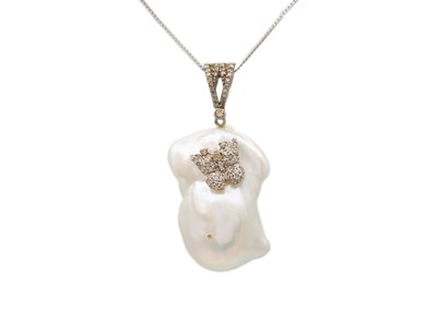 Lot 123 - A silver baroque pearl and diamond pendant on a fine curb chain.