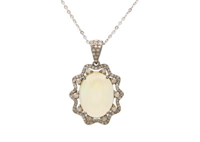 Lot 134 - An ornate silver opal and diamond pendant on a fine silver cable chain.