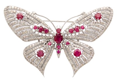 Lot 143 - A silver ruby and diamond set brooch/pendant.