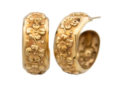 Lot 100 - A pair of 9k flower head embossed hoop earrings.