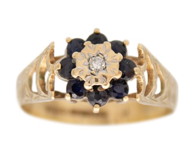 Lot 105 - A 9k diamond and sapphire set cluster ring.